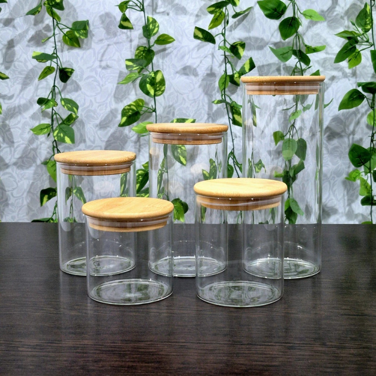 بانکه پیرکس گرد درب بامبو قطر ۸/۵ ارتفاع ۸،۱۰،۱۲،۱۵ و ۲۰ سانتیمتر Round Pyrex Storage Jar with Bamboo Lid — Diameter 8.5 cm, Heights 8, 10, 12, 15, and 20 cm