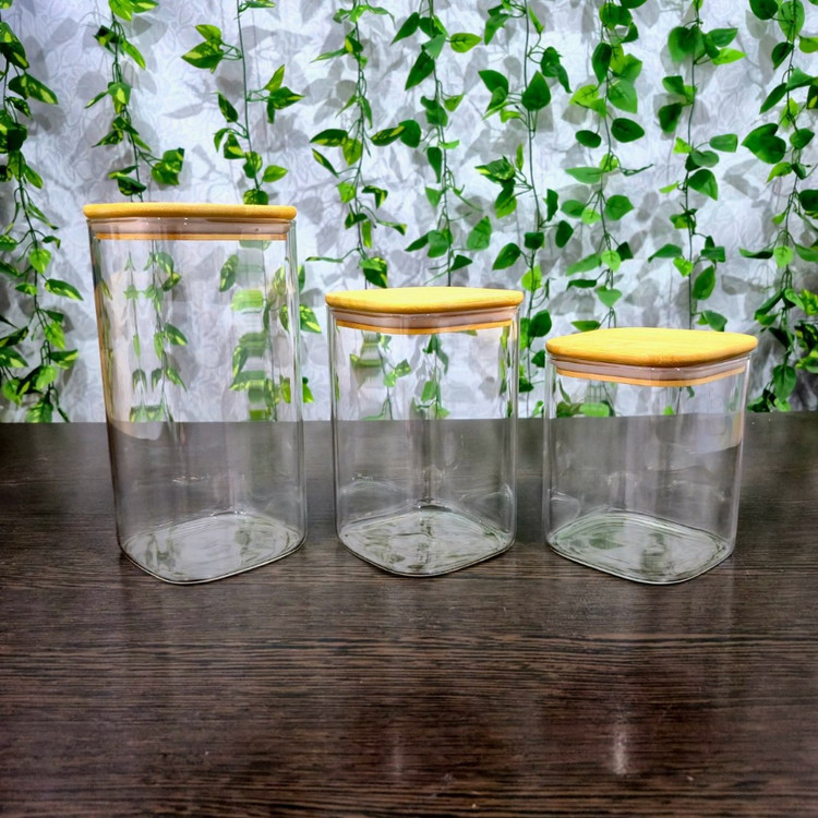 بانکه پیرکس مربعی ساده درب بامبو ابعاد کف ۱۰×۱۰ ارتفاع ۱۰،۱۵ و ۲۰ سانتی متر Simple Square Pyrex Storage Jar with Bamboo Lid — Base 10×10 cm, Heights 10, 15, and 20 cm